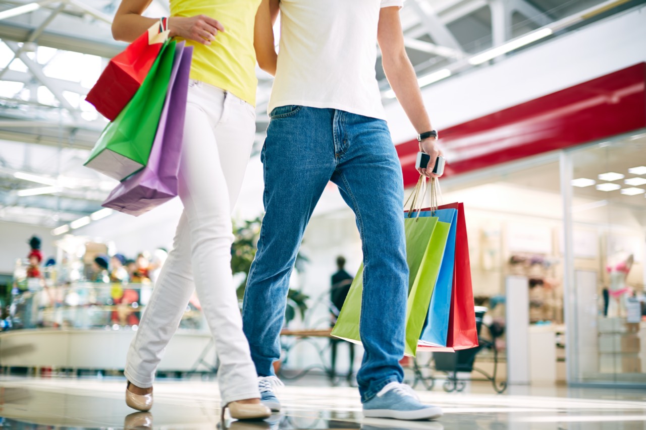 Legs of young couple going in the mall