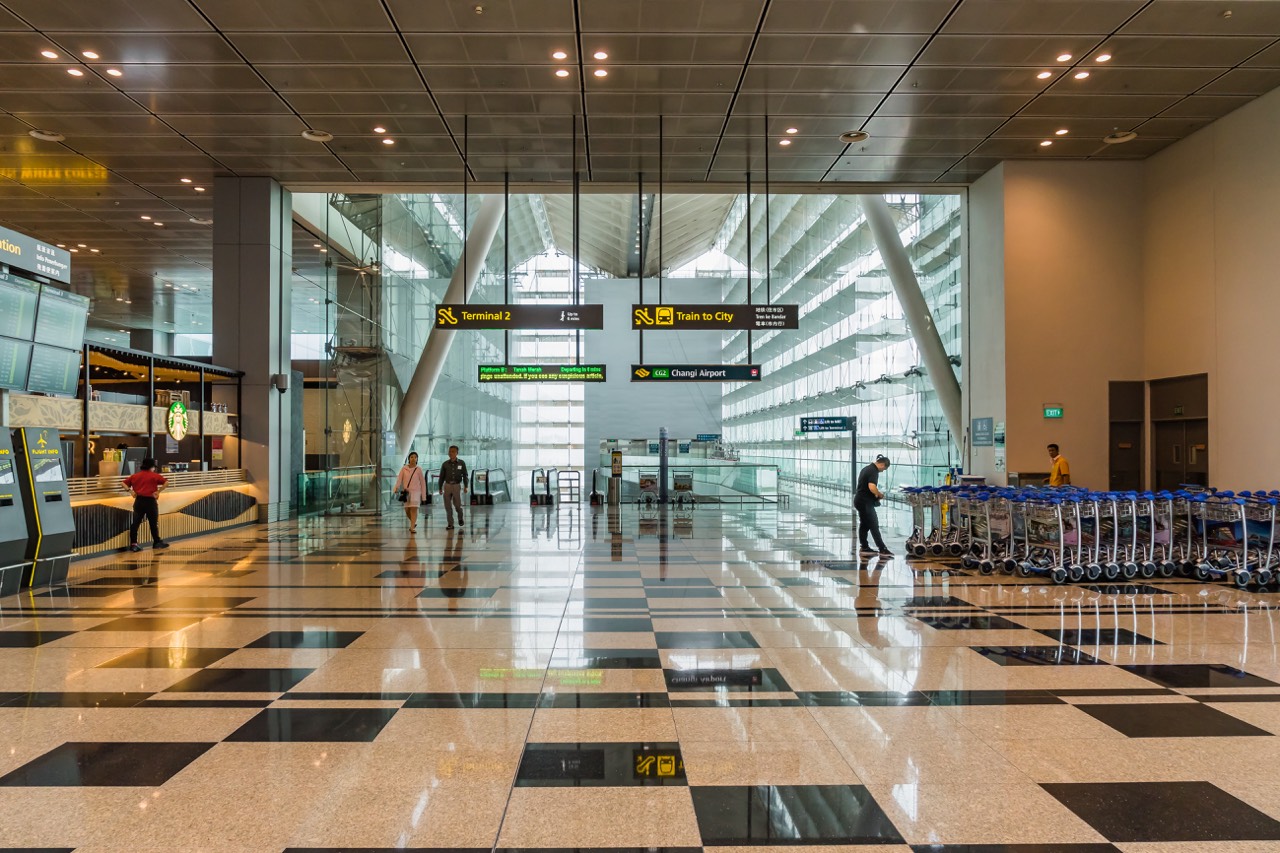 Singapore - July 8, 2017: Visitors walk from MRT train's exit into Departure Hall in Changi Airport Singapore. It has 3 passenger terminals, and is one of the largest transportation hubs in Asia and serves more than 100 airlines.